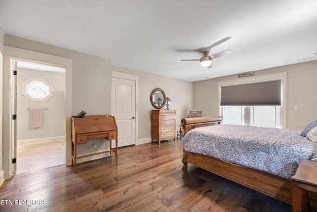 bedroom with hardwood / wood-style floors, multiple windows, and ceiling fan