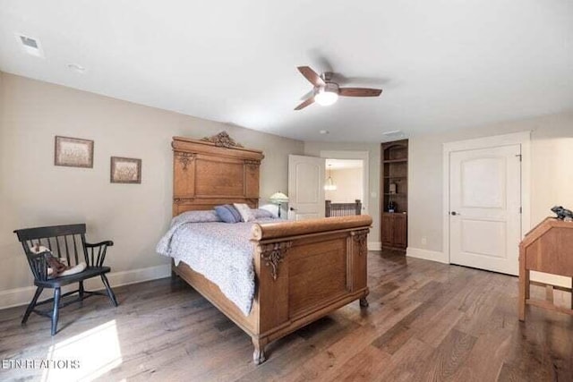 bedroom with ceiling fan and dark hardwood / wood-style floors