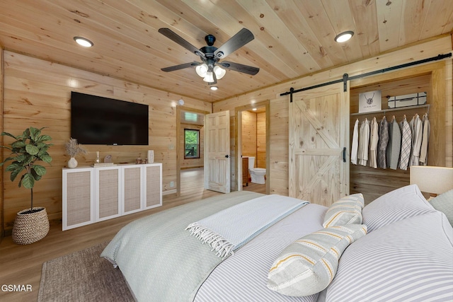 2641 Willow Heights Way, Sevierville, TN 37876 - bedroom featuring a barn door, wood finished floors, wood ceiling, wood walls, and recessed lighting