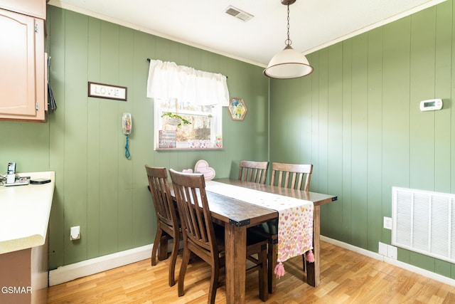 dining room featuring crown molding and light wood-type flooring