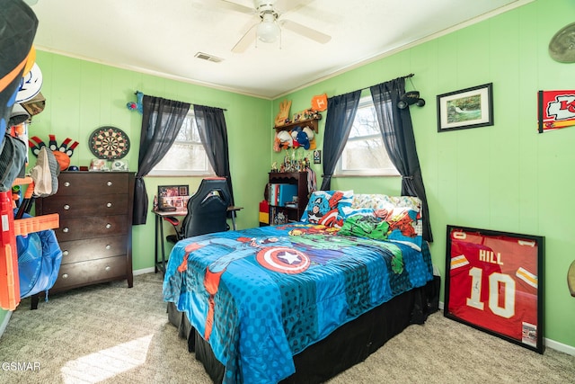 carpeted bedroom featuring ceiling fan and ornamental molding