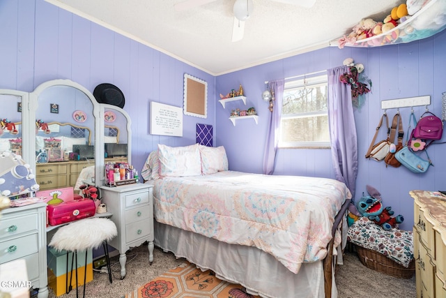 bedroom featuring a textured ceiling, ornamental molding, ceiling fan, and carpet