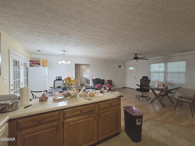 2865/2869 Happy Hollow Rd, Sevierville, TN 37862 - kitchen with freestanding refrigerator, a textured ceiling, light countertops, a chandelier, and ceiling fan