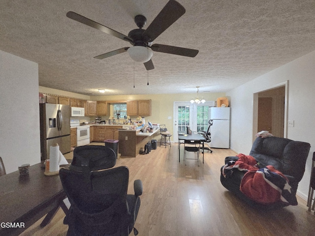 2865/2869 Happy Hollow Rd, Sevierville, TN 37862 - living room with a textured ceiling, light wood-style floors, ceiling fan, and a chandelier