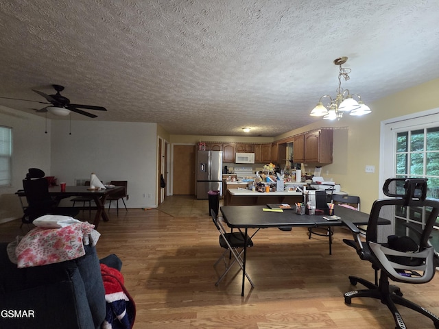 2865/2869 Happy Hollow Rd, Sevierville, TN 37862 - dining area featuring light wood-type flooring, a textured ceiling, a ceiling fan, a desk, and a chandelier