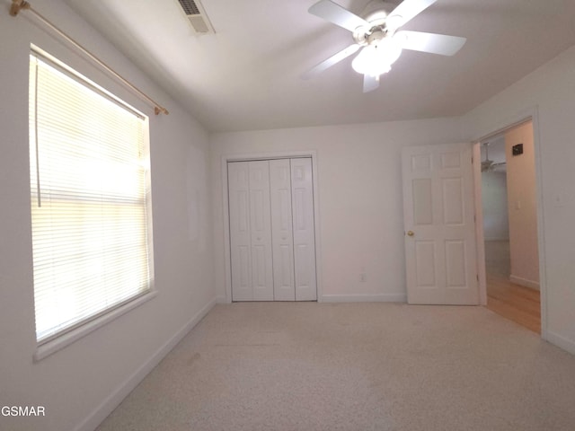 2865/2869 Happy Hollow Rd, Sevierville, TN 37862 - unfurnished bedroom featuring multiple windows, a closet, and light colored carpet