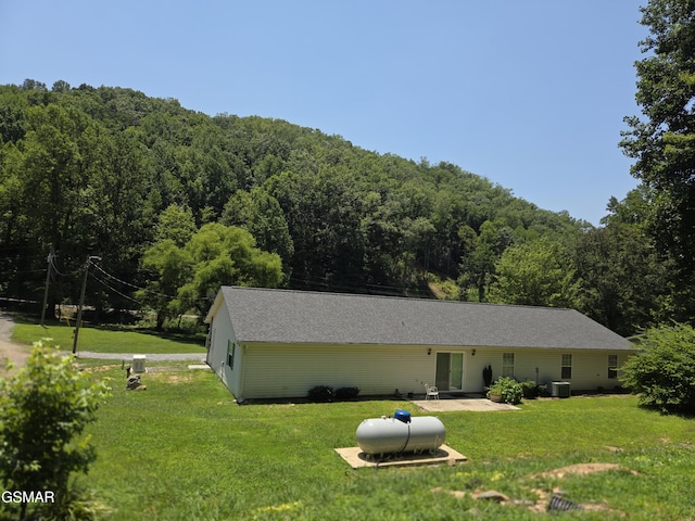 2865/2869 Happy Hollow Rd, Sevierville, TN 37862 - rear view of property featuring a wooded view, a yard, and a patio area