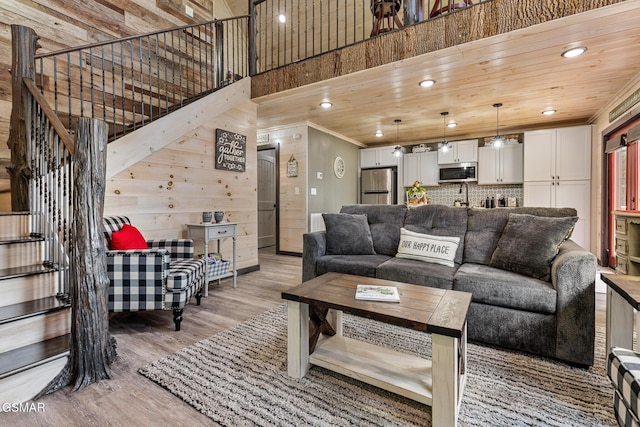 living room featuring hardwood / wood-style flooring, crown molding, and wooden ceiling