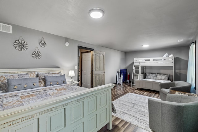 bedroom with dark hardwood / wood-style flooring