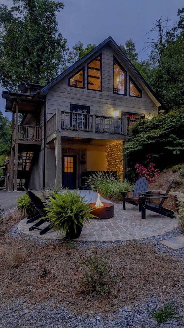 back of house featuring a patio and a fire pit