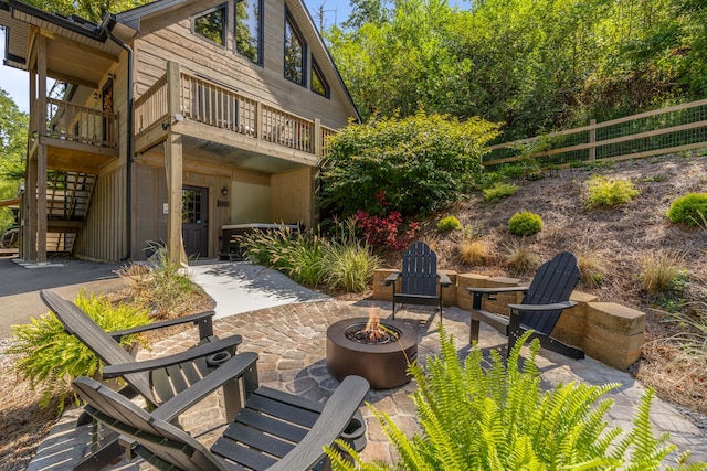 exterior space featuring a patio, a balcony, and a fire pit