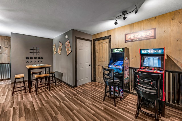 office area with dark hardwood / wood-style flooring and wood walls