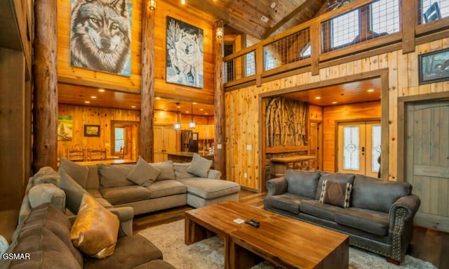 2716 Dayne Dr, Sevierville, TN 37862 - living area with wood finished floors, wood walls, french doors, high vaulted ceiling, and healthy amount of natural light
