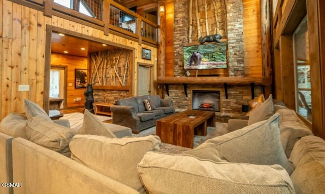 2716 Dayne Dr, Sevierville, TN 37862 - living room featuring wooden walls, a fireplace, plenty of natural light, and a high ceiling