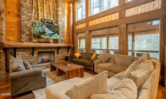 2716 Dayne Dr, Sevierville, TN 37862 - living room with a high ceiling, plenty of natural light, wood finished floors, a stone fireplace, and wood walls