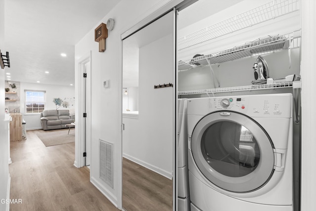 washroom featuring washer / dryer and wood-type flooring