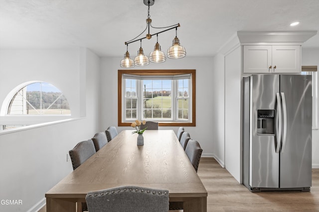 dining room with an inviting chandelier and light wood-type flooring