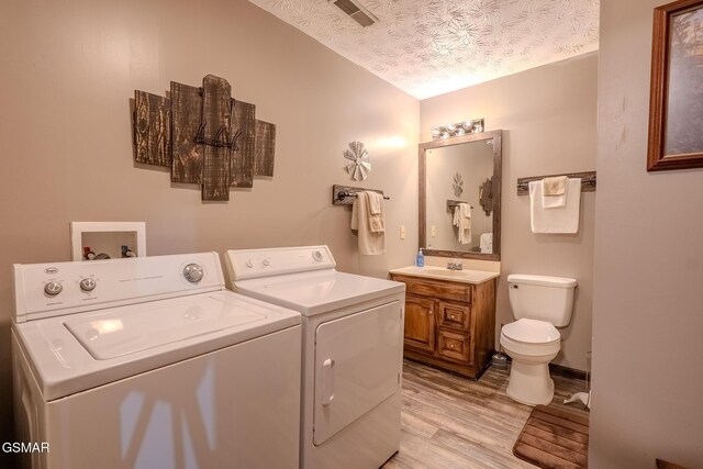 3078 Winding Way, Cosby, TN 37722 - washroom featuring independent washer and dryer, light wood finished floors, and a textured ceiling