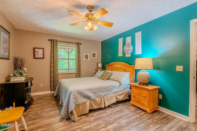 3078 Winding Way, Cosby, TN 37722 - bedroom featuring a textured ceiling, light wood-style floors, and a ceiling fan