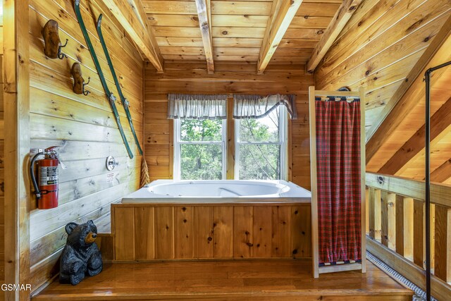 822 Eagle Cove Way, Gatlinburg, TN 37738 - bathroom featuring a garden tub, wood ceiling, wooden walls, and hardwood / wood-style flooring