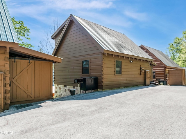 822 Eagle Cove Way, Gatlinburg, TN 37738 - view of home's exterior with log exterior and a metal roof
