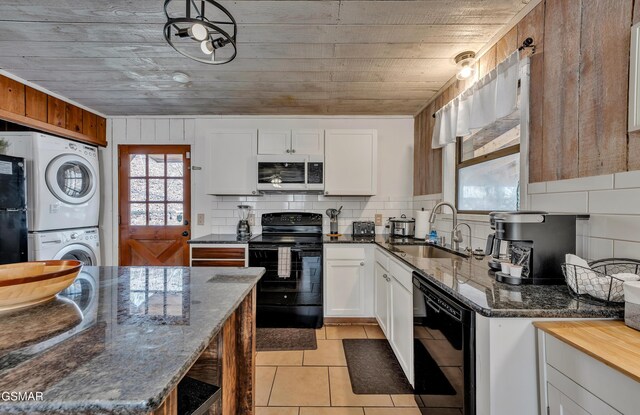 kitchen featuring white cabinets, black range with electric cooktop, a sink, and white microwave