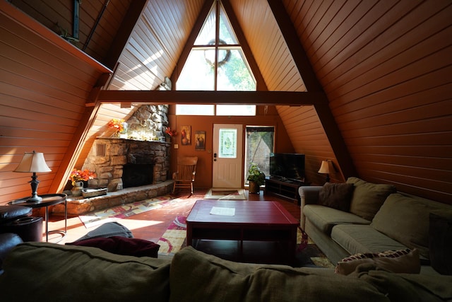 living room with wood walls, a fireplace, and a high ceiling