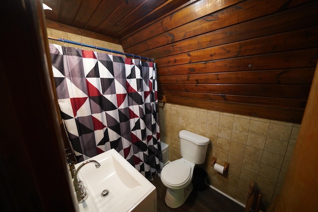 bathroom with wooden ceiling, sink, toilet, tile walls, and curtained shower