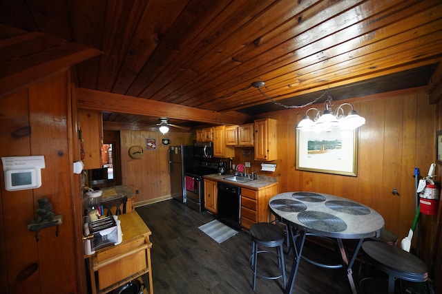 kitchen featuring beam ceiling, sink, dark hardwood / wood-style flooring, black appliances, and ceiling fan with notable chandelier