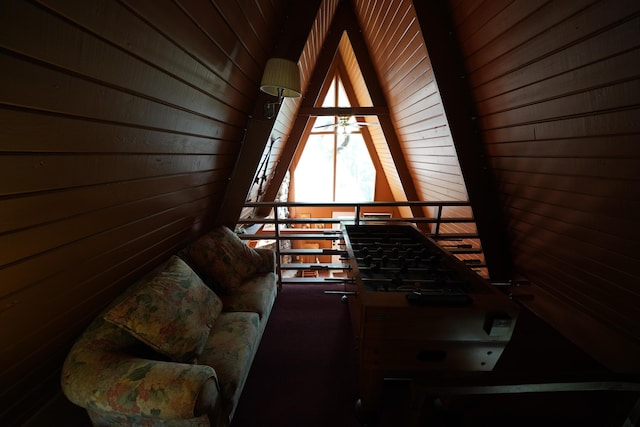 interior space featuring wood ceiling, ceiling fan, and wood walls