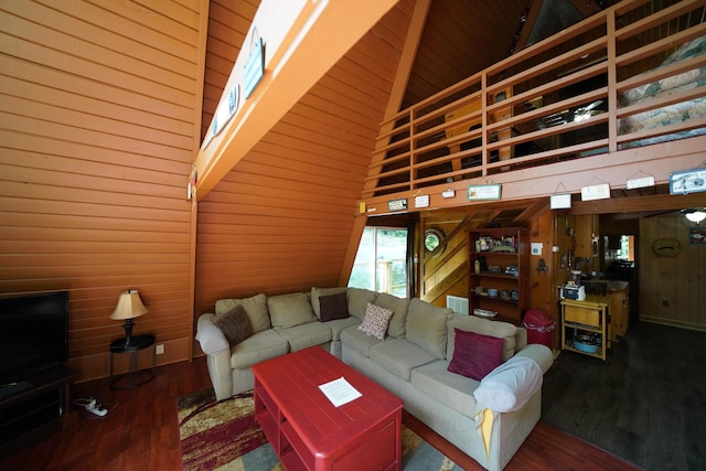 living room with hardwood / wood-style floors and high vaulted ceiling