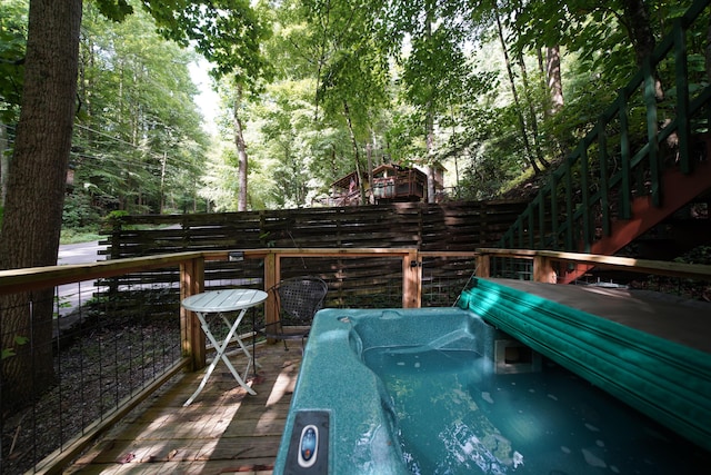 wooden terrace with an outdoor hot tub