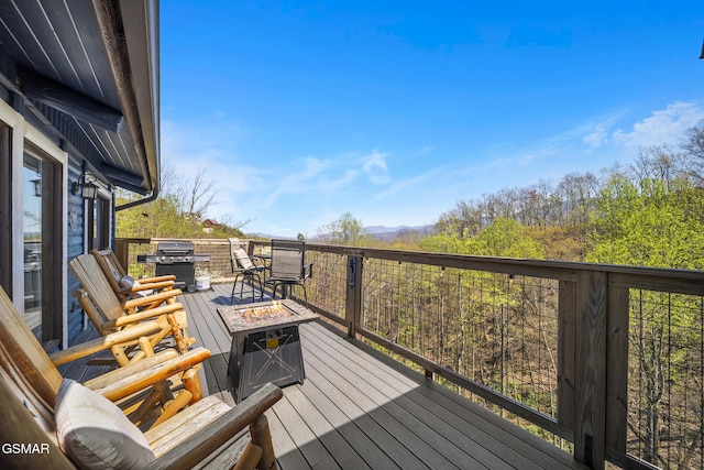 1023 Twin Oaks Rd, Gatlinburg, TN 37738 - wooden deck with a grill, an outdoor fire pit, and a mountain view