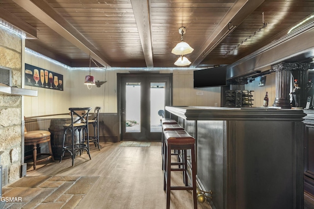 bar with french doors, a dry bar, wood ceiling, wood finished floors, and beamed ceiling