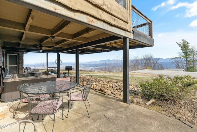 view of patio featuring outdoor dining area and a mountain view