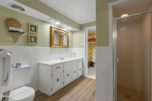 full bathroom featuring visible vents, crown molding, vanity, a shower stall, and tile walls