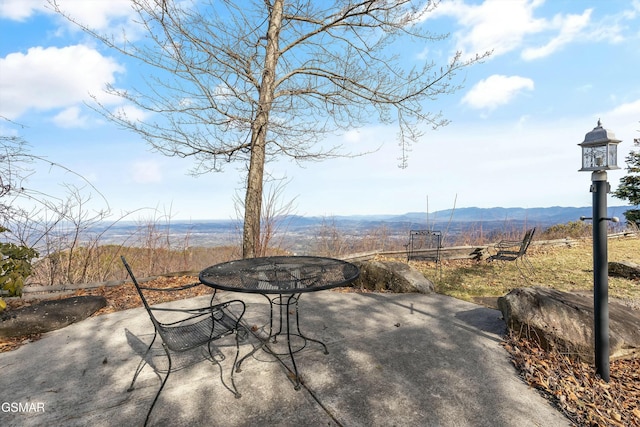 view of patio / terrace featuring a mountain view