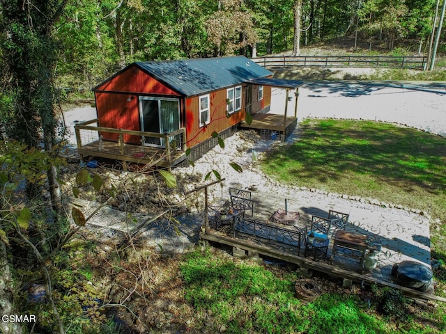 rear view of property with a yard and a wooden deck