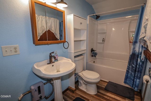 full bathroom with sink, hardwood / wood-style floors, shower / bath combination with curtain, and toilet