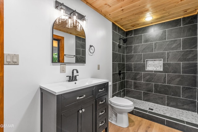 full bathroom with wooden ceiling, toilet, wood finished floors, vanity, and a shower stall