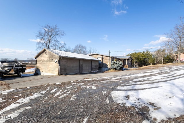 1369 Paradise Ln, Dandridge, TN 37725 - view of home's exterior featuring a garage, a metal roof, and an outdoor structure
