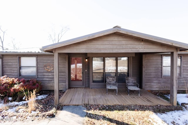 1369 Paradise Ln, Dandridge, TN 37725 - snow covered property entrance with a metal roof and a deck