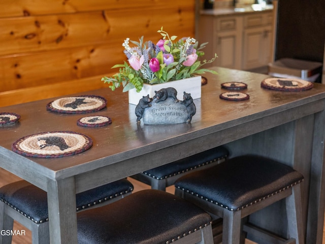 dining room with wooden walls