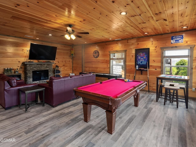 recreation room with hardwood / wood-style floors, ceiling fan, a fireplace, and pool table