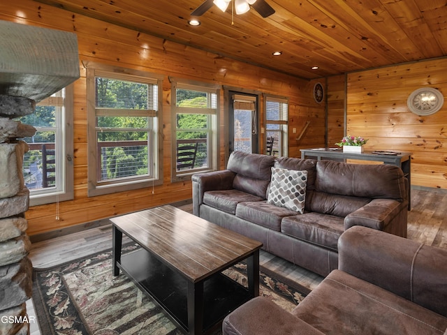 living room with hardwood / wood-style floors, wood walls, and wood ceiling