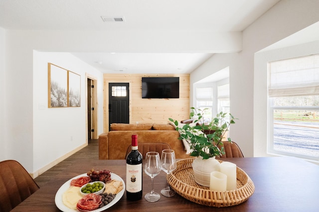 dining room featuring a wealth of natural light, wood finished floors, visible vents, and baseboards