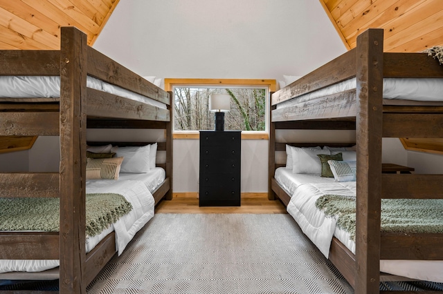 bedroom with lofted ceiling and wood finished floors