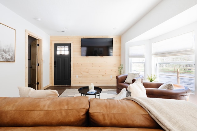 living room featuring wooden walls and wood finished floors