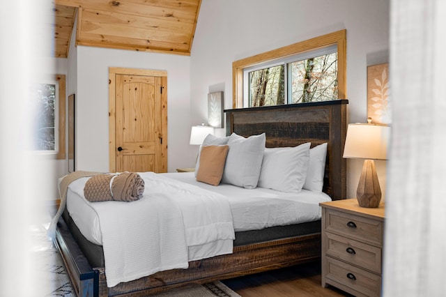 bedroom featuring vaulted ceiling, wood finished floors, and wood ceiling