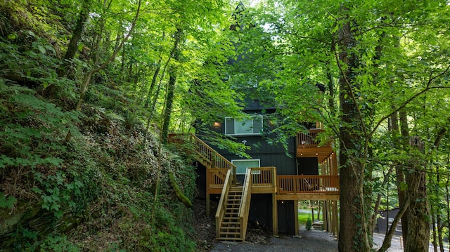 view of play area with stairway and a view of trees